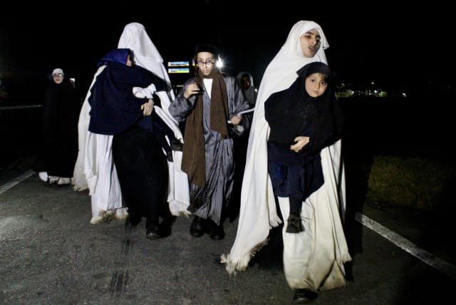  Members of the fundamentalist Jewish sect Lev Tahor, whose members are suspected of a string of serious crimes, walk along a road after escaping from a detention center where they were being held following a raid, in Huixtla, Chiapas state, Mexico September 28, 2022. (photo credit: REUTERS/JOSE TORRES)