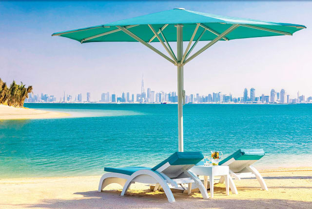  THE BEACHFRONT of an artificial hotel with Dubai skyline.  (photo credit: Courtesy of Anantara World Islands Resort)