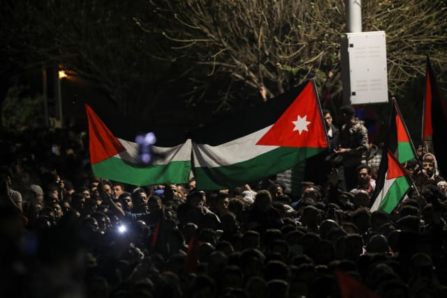 People hold Palestinian and Jordanian flags, during a protest in support of Palestinians in Gaza, amid the ongoing conflict between Israel and the Palestinian Islamist group Hamas, near the Israeli embassy in Amman, Jordan, March 29, 2024. (photo credit: REUTERS/Alaa Al-Sukhni)