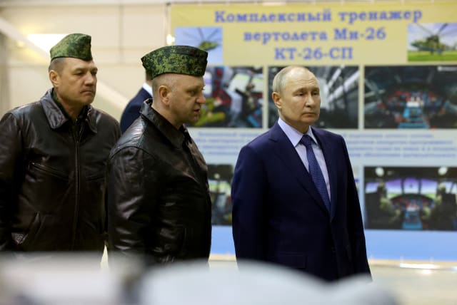  Russian President Vladimir Putin, accompanied by Hero of Russia, head of air combat and tactical training Alexander Karamyshev, visits the 344th State Centre for combat use and retraining of flight crews of the Russian Defense Ministry in the town of Torzhok, Russia March 27, 2024. (photo credit: VIA REUTERS)