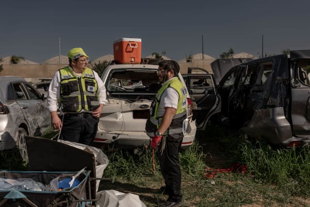  Zaka personnel work at a field with destroyed cars from the October 7 massacre, near the Israel-Gaza border, January 22, 2024. (photo credit: CHEN SCHIMMEL/FLASH90)