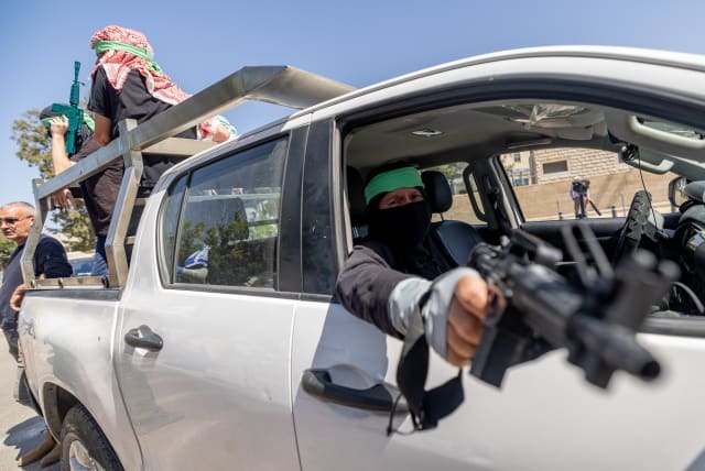  Activists dressed as Hamas terrorists protest against UNRWA outside their offices in Jerusalem, April 3, 2024 (photo credit: YONATAN SINDEL/FLASH90)