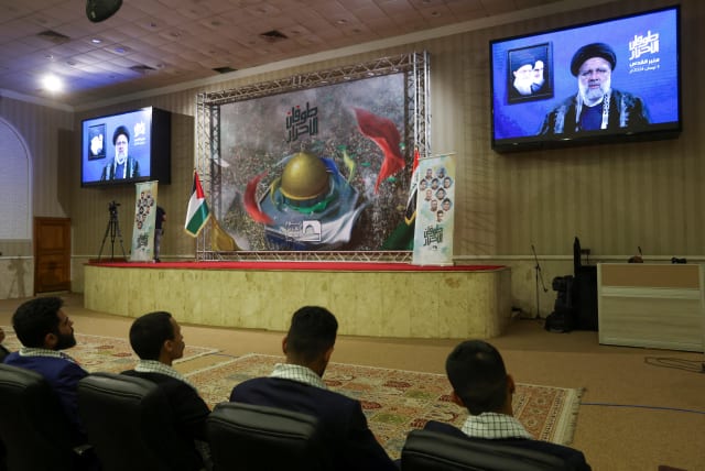  Supporters of Iraqi Shi'ite armed groups watch a televised speech by Iranian President Ebrahim Raisi, ahead of Al-Quds (Jerusalem) Day, in Baghdad, Iraq, April 3, 2024. (photo credit: REUTERS/AHMED SAAD)