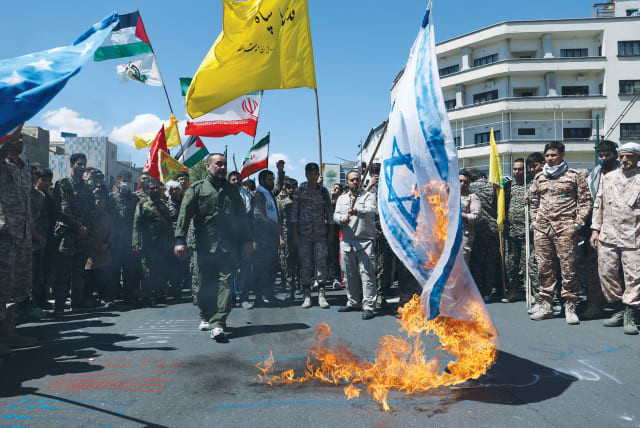  AN ISRAELI flag is burned during a rally marking the annual al-Quds Day, Jerusalem Day, in Tehran, last year.  (photo credit: WEST ASIA NEWS AGENCY/REUTERS)