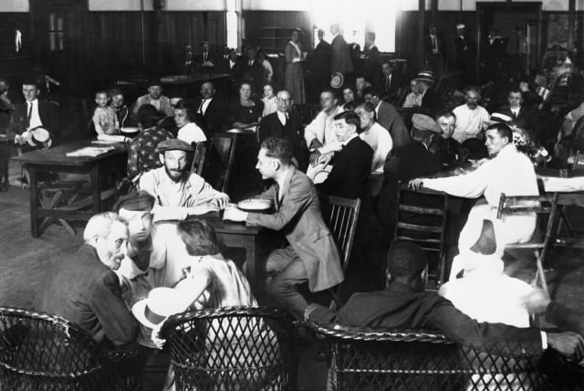 Immigrants awaiting approval of their entry into the U. S. crowd the lunchroom for their noonday meal at Ellis Island, 1923. The next year the U.S. would adopt legislation severely restricting immigration. (photo credit:  (Bettmann/Getty Images))