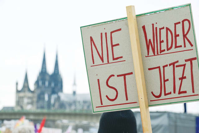  A DEMONSTRATOR holds a sign that reads “Never Again is Now” during a protest against right-wing extremism and the far-Right opposition Alternative for Germany (AfD), in Cologne, in January.  (photo credit: Jana Rodenbusch/Reuters)