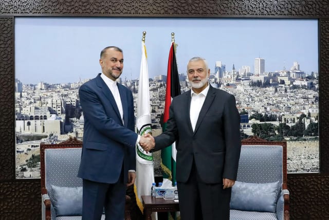  Iran’s Foreign Minister Hossein Amir Abdollahian meets Hamas leader Ismail Haniyeh in Doha, Qatar, on February 13, 2024. In the background is a large photograph of Jerusalem. (photo credit: WANA/REUTERS)