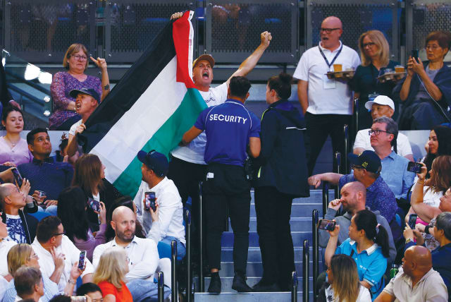  SECURITY PERSONNEL eject from the stands a fan displaying a flag in support of Palestine during the women’s final match at the Australian Open tennis tournament in Melbourne, in January. (photo credit: Issei Kato/Reuters)