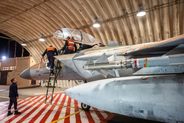 Crews work on an Israeli Air Force F-15 Eagle in a hangar, said to be following an interception mission of an Iranian drone and missile attack on Israel, in this handout image released April 14, 2024. (photo credit: Israel Defense Forces/Handout via REUTERS)
