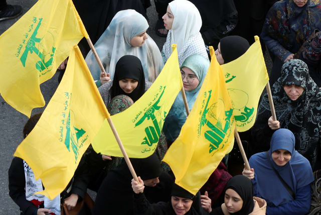  Women and youths carry Hezbollah flags during a demonstration in support of Palestinians in Gaza, amid the ongoing conflict between Israel and the Palestinian Islamist group Hamas, in Beirut, Lebanon March 2, 2024. (photo credit: REUTERS/MOHAMED AZAKIR)