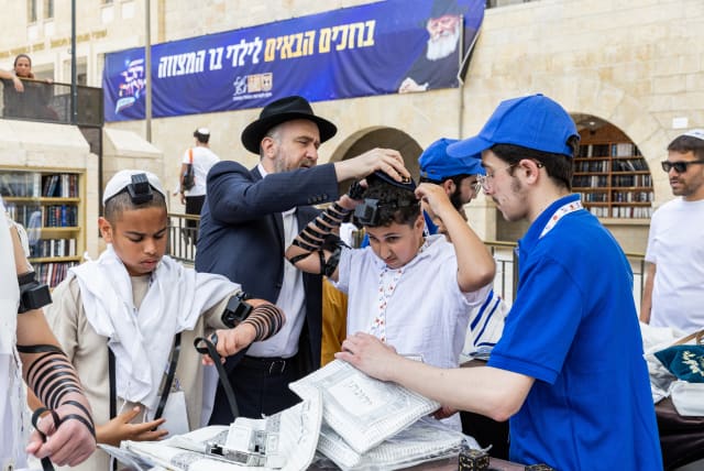  Young men who have lost parents celebrate becoming bar mitzvahs at the Western Wall. (photo credit: MENDY KORNET)