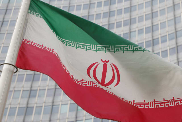   The Iranian flag flutters outside the International Atomic Energy Agency (IAEA) headquarters in Vienna, Austria, March 6, 2023.  (photo credit: REUTERS/LEONHARD FOEGER/FILE PHOTO)