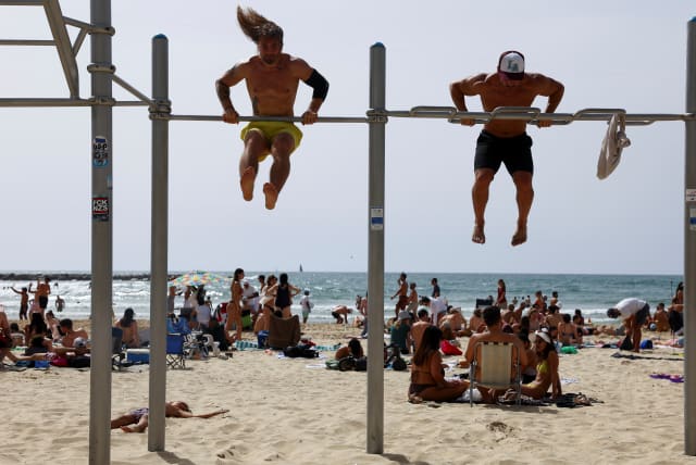 People exercise at the beach in Tel Aviv, Israel April 20, 2024. (photo credit: REUTERS/HANNAH MCKAY)