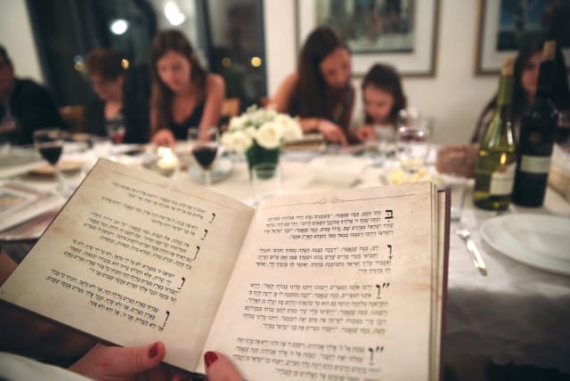  NO MATTER what traditions people bring to the Seder, the constant is the Haggadah. (photo credit: YAHAV GAMLIEL/FLASH90)