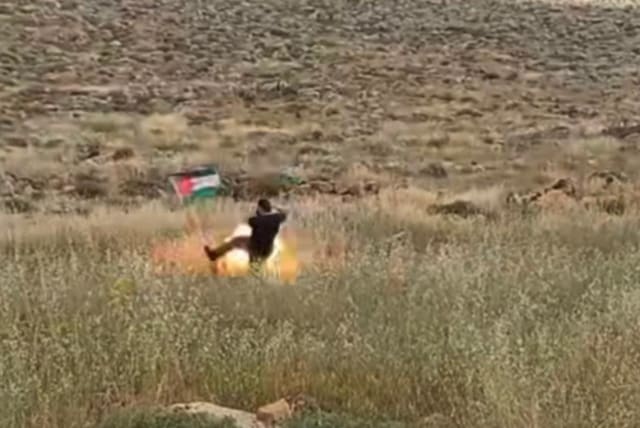  Footage of an Israeli going to take down a Palestinian flag before the explosive device went off in Kochav Hashahar, in the West Bank. April 21, 2024. (photo credit: Screenshot/Instagram)