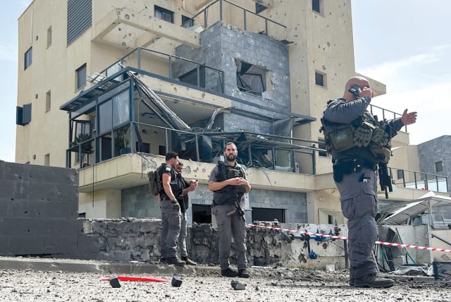  Israeli police work at the site of a lethal rocket strike at a factory in Kiryat Shmona on March 27.  (photo credit: Avi Ohayon/Reuters)