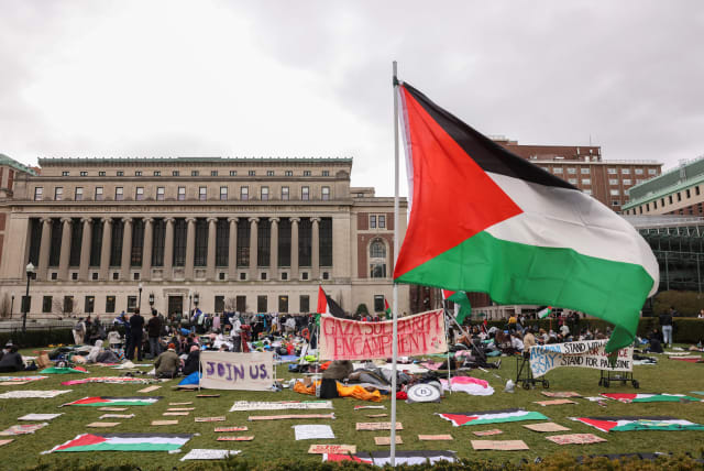  Demonstrators sit in an encampment as they protest in solidarity with Pro-Palestinian organizers on the Columbia University campus, amid the ongoing conflict between Israel and Hamas, in New York City, US. April 19, 2024. (photo credit: CAITLIN OCHS/REUTERS)
