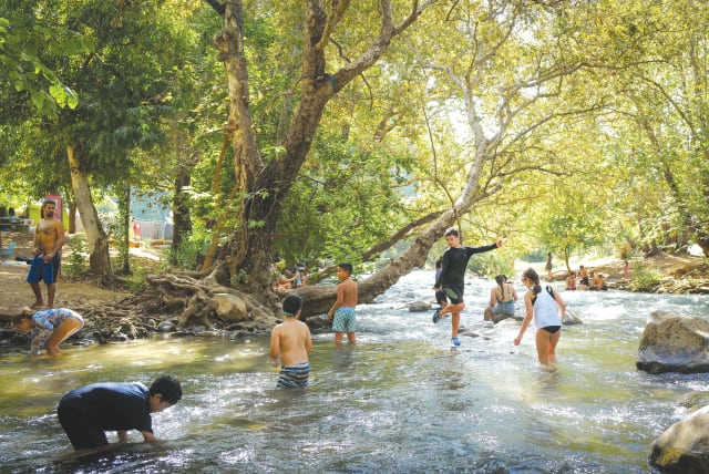  FAMILIES VACATION at the Hasbani River in the Upper Galilee last year. Importantly, 21% of families in the North rely on tourism for their income, the writer notes. (photo credit: MICHAEL GILADI/FLASH90)