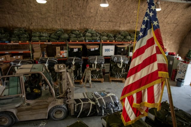  U.S. Air Force members work on the preparation of a humanitarian aid drop for Gaza residents, in this picture released on March 5, 2024. (photo credit:  US Central Command via X/Handout via REUTERS )