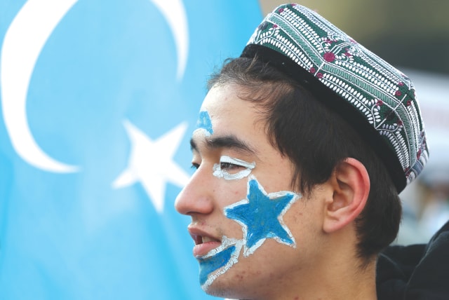  A man from China's Uyghur Muslim ethnic group. A recent interfaith panel took place in New York looking at the human rights violations against the Uyghurs by the Chinese government. (photo credit: MURAD SEZER/REUTERS)