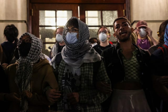  Protesters link arms outside Hamilton Hall barricading students inside the building at Columbia University,  in New York City, U.S., April 30, 2024. (photo credit: CAITLIN OCHS/REUTERS)