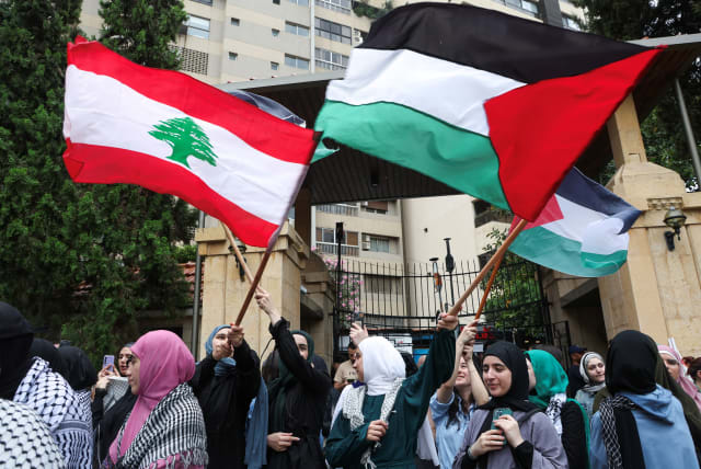  Demonstrators hold Lebanese and Palestinian flags during a protest in solidarity with Gaza at the Lebanese American University (LAU), in Beirut, Lebanon April 30, 2024. (photo credit: REUTERS/MOHAMED AZAKIR)