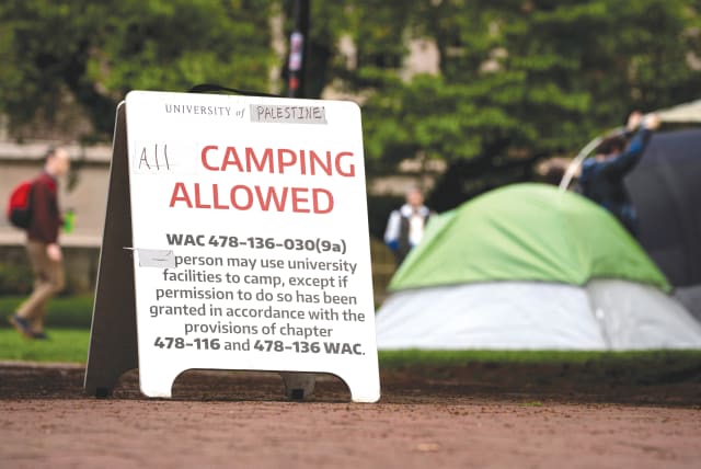  A SIGN modified by demonstrators to read ‘University of Palestine’ that allows ‘all’ camping at a protest encampment in support of Palestinians at the University of Washington in Seattle, this week.  (photo credit: David Ryder/Reuters)