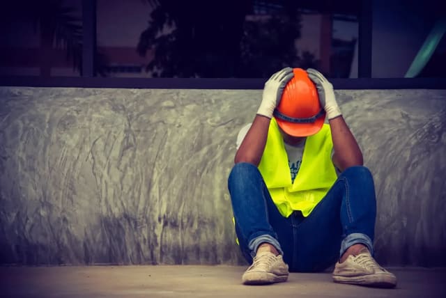  A frustrated construction worker. (photo credit: SHUTTERSTOCK)