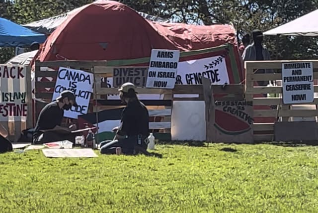  People sitting on the grass infront of UVIC pro-Palestine protest encampment. 4/5/2024 (photo credit: MICHAEL STARR)