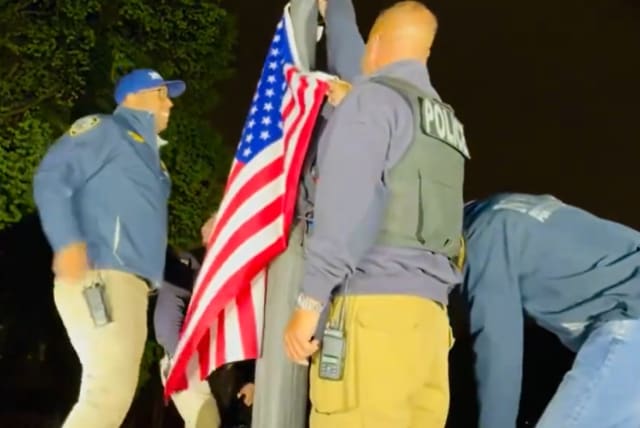  NYPD puts US flag back on pole after clearing pro-Palestinian protest. Uploaded 4/5/2024 (photo credit: NYPD)