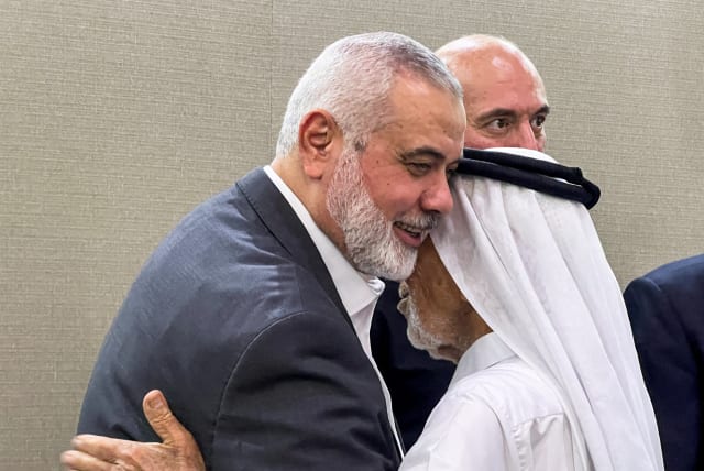  Ismail Haniyeh, top leader of the Palestinian Islamist group Hamas, meets a person offering condolences after the killing of three of his sons in an Israeli strike in Gaza City, in Doha, Qatar April 11, 2024. (photo credit: REUTERS/IBRAHEEM ABU MUSTAFA)