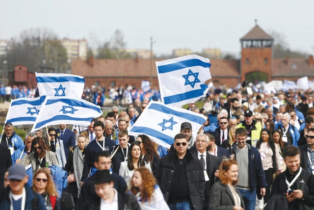  PARTICIPANTS WAVE Israeli flags at the annual International March of the Living at Auschwitz-Birkenau, on Holocaust Remembrance Day last year.  (photo credit: Agencja Wyborcza.pl/Reuters)