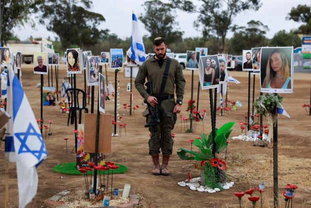 An Israeli soldier stands during a two-minute siren marking the annual Israeli Holocaust Remembrance Day, at an installation at the site of the Nova festival where party goers were killed and kidnapped during the October 7 massacre by Hamas terrorists, in Reim, southern Israel, May 6, 2024.  (photo credit: AMMAR AWAD/REUTERS)