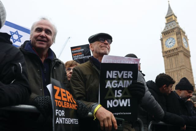  DEMONSTRATORS HOLD placards at a march against antisemitism, in November in London. The writer asks: Why should we fight to remain in societies that at worst seem hostile to us and at best seem indifferent? (photo credit: Susannah Ireland/Reuters)
