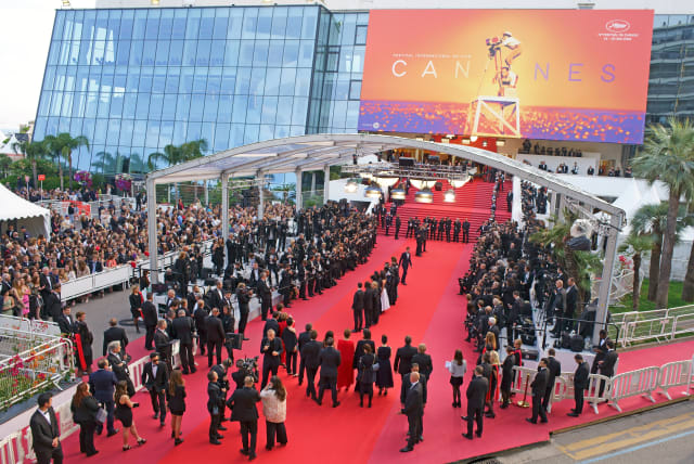  Caption: AERIAL VIEW from a 6-meter mast. Actors posing for photographers on the red carpet before going up the famous 24 steps. Cannes Film Festival, France.