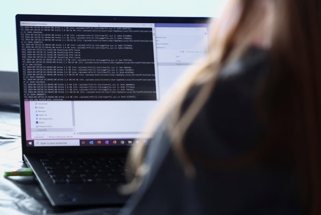  A cybersecurity employee from the Paris 2024 flying squad manages a simulated cyber attack and pretends to resolve it from a computer on the Olympic site which will host the hockey events at Yves-du-Manoir Stadium in Colombes, near Paris, France, May 3, 2024. 