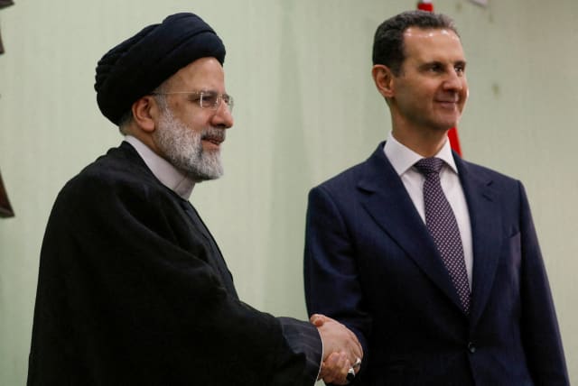   Syria's President Bashar al-Assad shakes hands with Iranian President Ebrahim Raisi during the signing of cooperation agreement in Damascus, Syria May 3, 2023. 