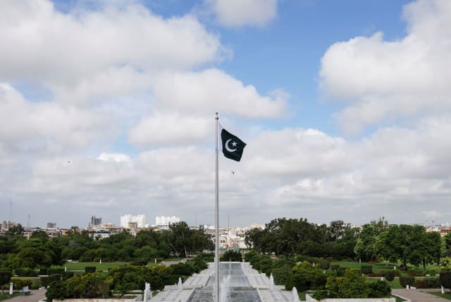  Pakistan's national flag flatters during a ceremony to celebrate Pakistan's 75th Independence Day, at the Mausoleum of Muhammad Ali Jinnah in Karachi, Pakistan August 14, 2022. (photo credit: REUTERS/AKHTAR SOOMRO)