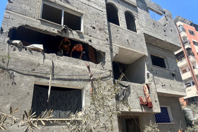  Palestinians inspect the site of an Israeli strike in Nuseirat refugee camp in the central Gaza Strip, June 6, 2024 (photo credit: REUTERS/EMAD ABU SHAWIESH)