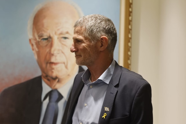 Labor leader Yair Golan poses next to a photo of former prime minister Yitzhak Rabin, June 17, 2024 (photo credit: MARC ISRAEL SELLEM)