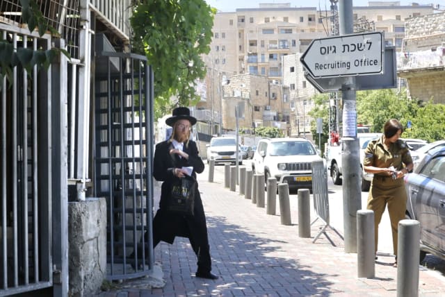  An ultra-Orthodox Jewish man is seen exiting an IDF recruiting office in Jerusalem, June 25, 2024 (photo credit: MARC ISRAEL SELLEM/THE JERUSALEM POST)