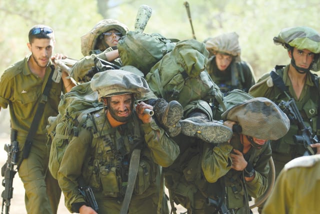  IDF SOLDIERS take part in an army stretcher drill. Israel’s population also needs to carry its share of the burden.