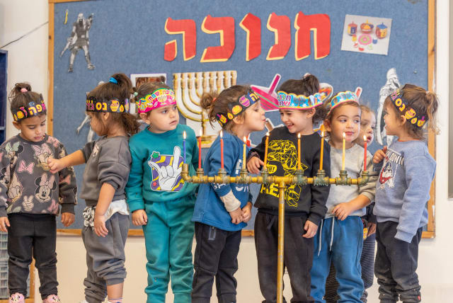  Children in school are seen around a menorah ahead of Hanukkah.