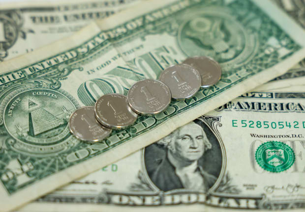  US and Israeli currency (1 dollar bills and 1 shekel coins respectively) are seen in this illustrative photo of money.