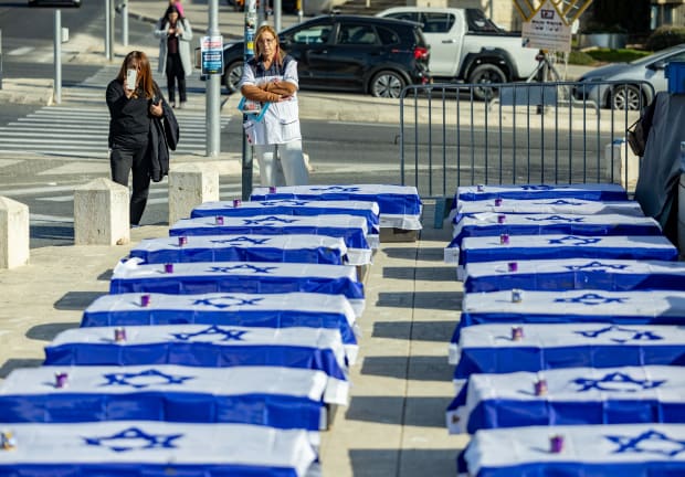  EMPTY COFFINS line a street  near the Prime Minister’s Office,  in protest of the ceasefire deal,  Jan. 16 in Jerusalem.