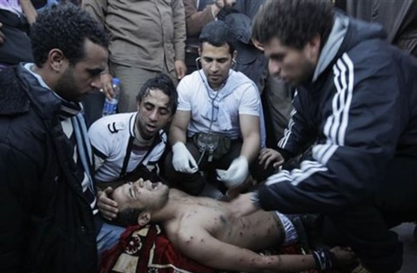 Egyptian protester has his injuries tended to - Gallery