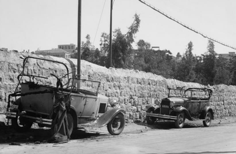 Two destroyed cars owned by Jews, 1936.