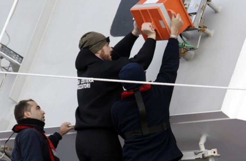 Italian Coast Guard personnel recover the black box