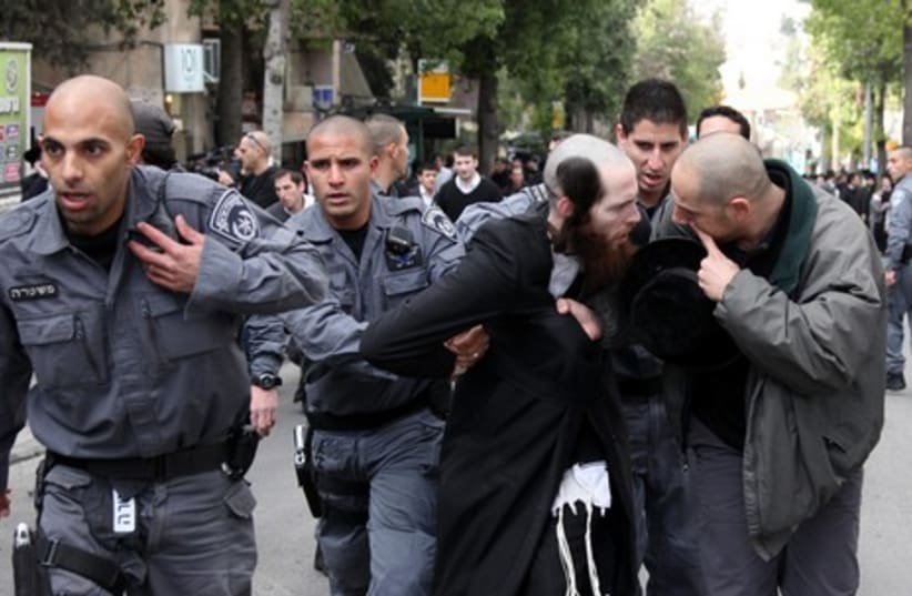 A man is arrested as hundreds protest in Jerusalem