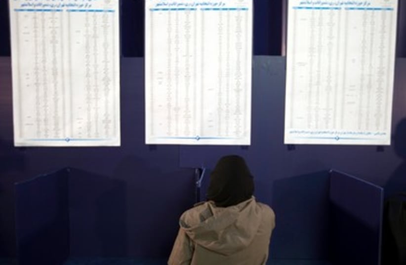 Iranian woman looks at voting lists